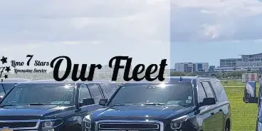 A fleet of black luxury SUVs and vans parked in a row at an airport.