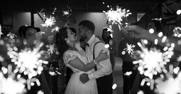 Newlyweds embrace amid sparklers at a wedding by DJ MC Brooklyn Entertainment, Kings Park NY