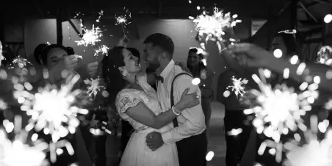 Newlyweds embrace amid sparklers at a wedding by DJ MC Brooklyn Entertainment, Kings Park NY