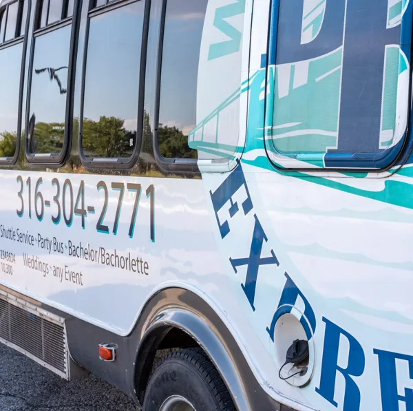 Side view of a white shuttle bus with 'Triple B's Express' branding and service details.