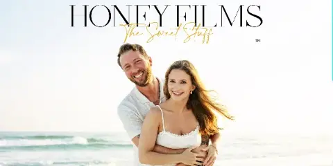 A smiling couple embracing on a beach with the Honey Films logo overlaid.