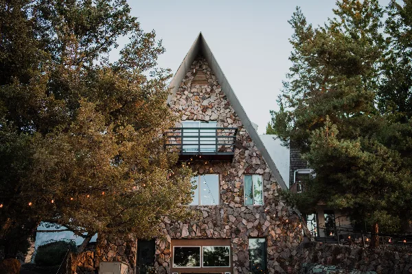 Exterior view of the stone-clad A-frame building at the Stone Crossing estate venue.