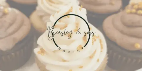Close-up photograph of cupcakes with white frosting and gold sprinkles, featuring the Beasley & Sons Bakery logo overlay.