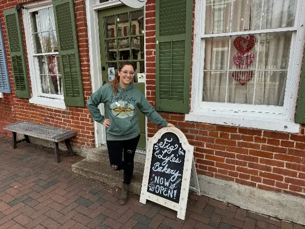 Exterior of Fig & Lyle's Bakery storefront with a chalkboard sign reading 'Fig & Lyle's Bakery Now Open'