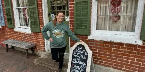Exterior of Fig & Lyle's Bakery storefront with a chalkboard sign reading 'Fig & Lyle's Bakery Now Open'
