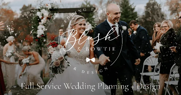 A bride and groom walking down the aisle at an outdoor wedding ceremony with a floral arch and guests.