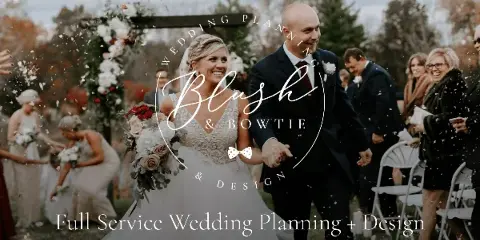 A bride and groom walking down the aisle at an outdoor wedding ceremony with a floral arch and guests.