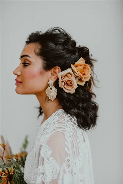Profile view of a bride with styled updo hair and makeup