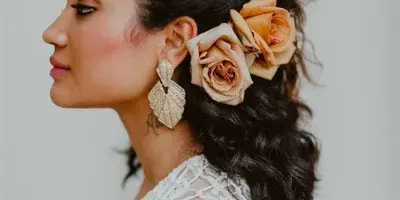 Profile view of a bride with styled updo hair and makeup