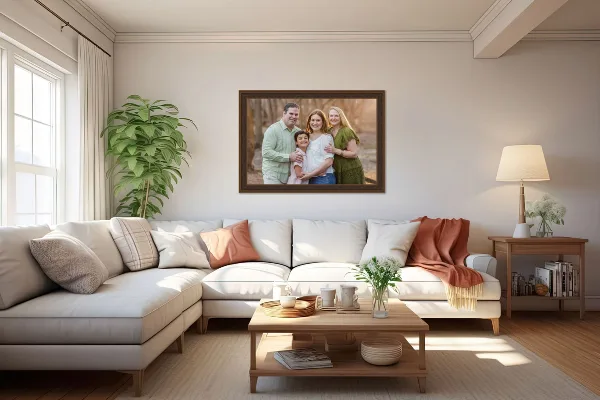 A framed family portrait photograph hanging on a wall above a sofa in a living room.