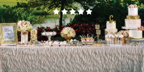 A wedding dessert table featuring multi-tiered cakes, cupcakes, and assorted sweets.