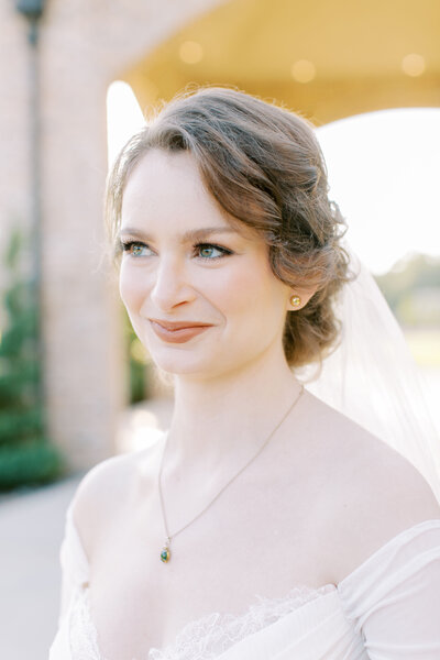 Portrait of a bride with an elegant updo hairstyle and soft makeup.