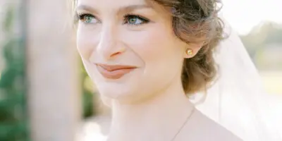 Portrait of a bride with an elegant updo hairstyle and soft makeup.