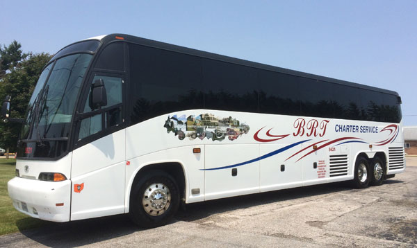 A white BRT Charter Service motorcoach parked outdoors.