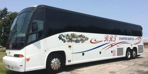 A white BRT Charter Service motorcoach parked outdoors.