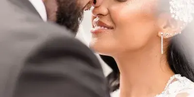 A close-up fine art wedding photograph of a bride and groom touching foreheads.