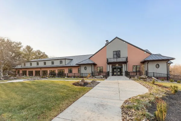 Exterior view of the Wakefield Valley Park Event Center building with a paved walkway leading to the entrance.