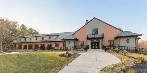 Exterior view of the Wakefield Valley Park Event Center building with a paved walkway leading to the entrance.