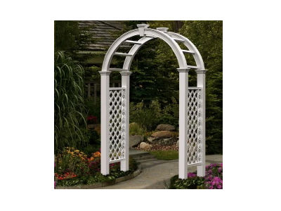 A white decorative garden archway standing in a landscaped outdoor setting.