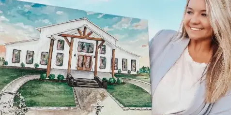 A woman holding a painting of a white wedding venue building with a fountain in the foreground.