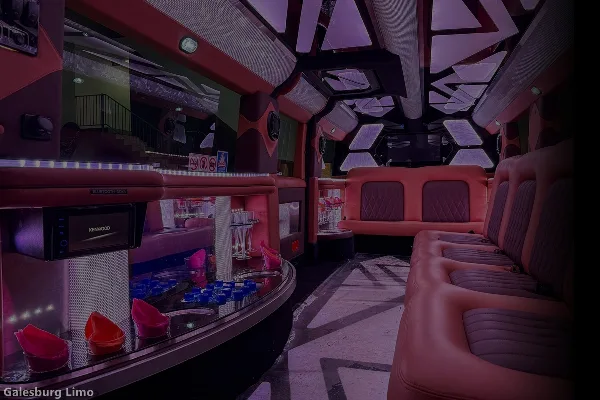 Interior view of a party bus with red leather seating, a bar counter, and purple ambient lighting.